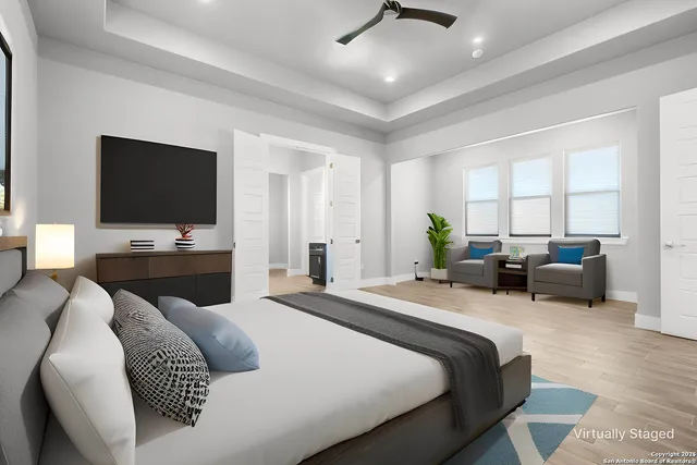 a bedroom with a large bed and a tv