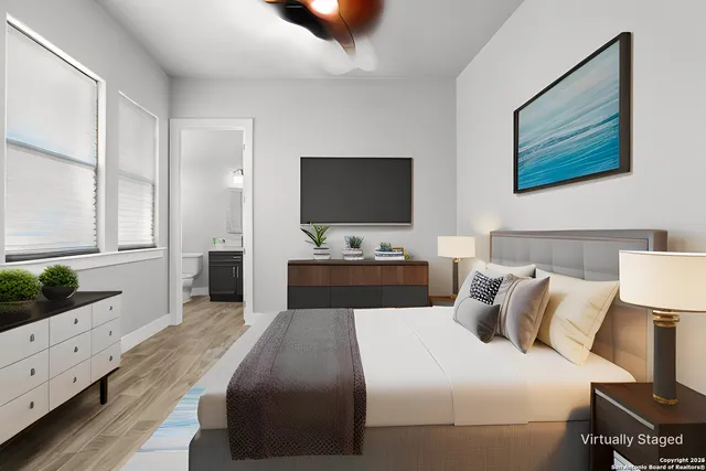 a bedroom with a bed and a flat screen tv