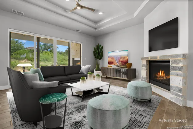 a living room with furniture a flat screen tv and a fireplace