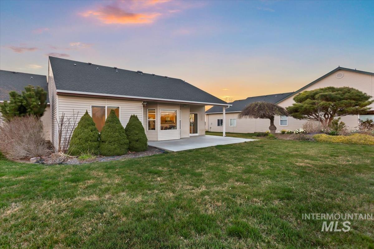 25074 The Driving Lane Caldwell, ID 83607 - Photo 29 of 32 Rear view of property with a patio area and a yard