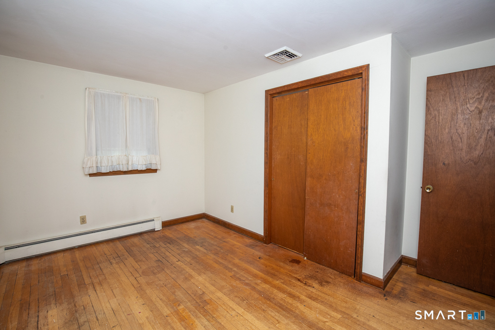 64 Somer Drive Meriden, CT 06451 - Photo 18 of 28 an empty room with wooden floor and windows