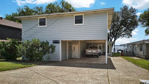a car parked in front of a white house