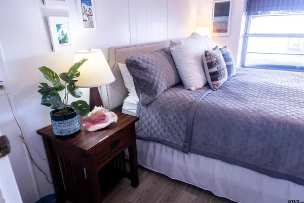 a bedroom with a bed and a chandelier