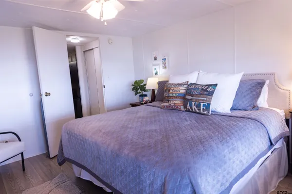 a bedroom with a bed and a window