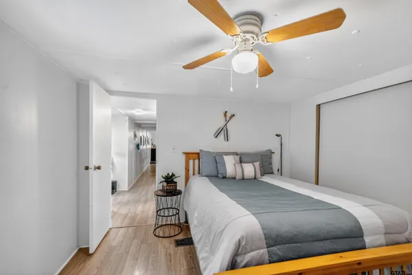 a bedroom with a bed couch and window