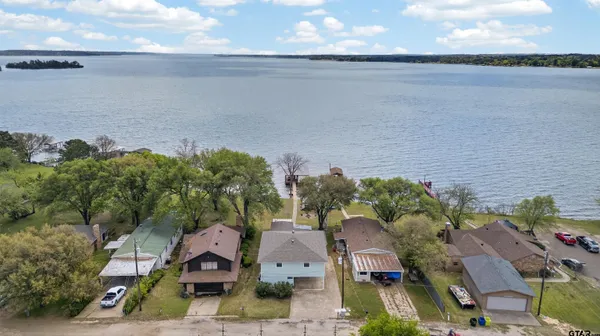 an aerial view of a house with a lake view
