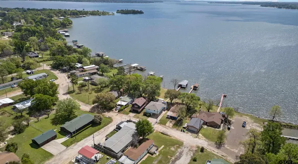 an aerial view of a houses with a yard