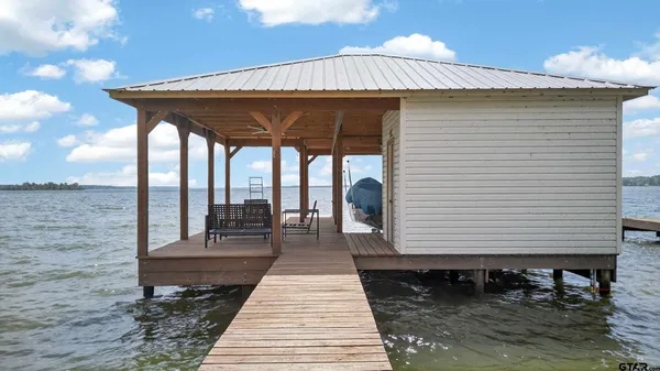 a swimming pool with outdoor seating and yard