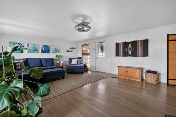 a living room with furniture and a flat screen tv