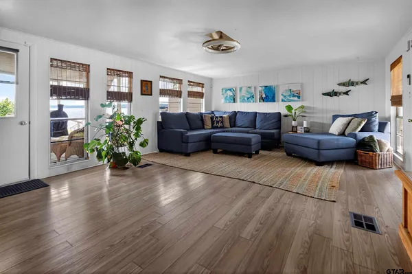 a view of a dining room with furniture and wooden floor