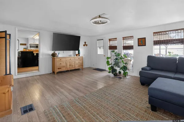 a view of a dining room with furniture and wooden floor