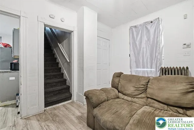 a living room with furniture and stairs