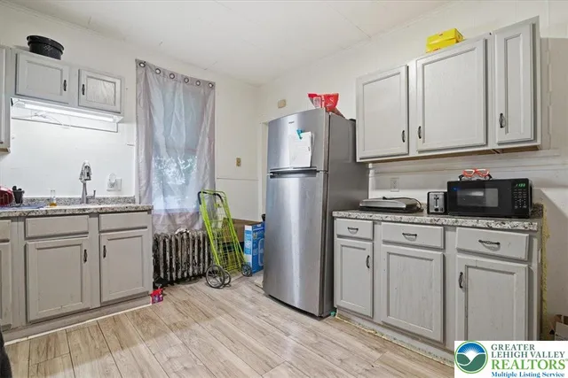 a kitchen with stainless steel appliances granite countertop a refrigerator sink and cabinets