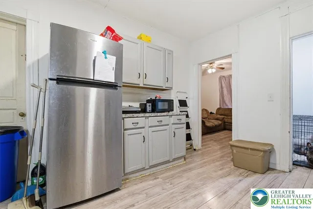 a kitchen with stainless steel appliances granite countertop a refrigerator sink and stove