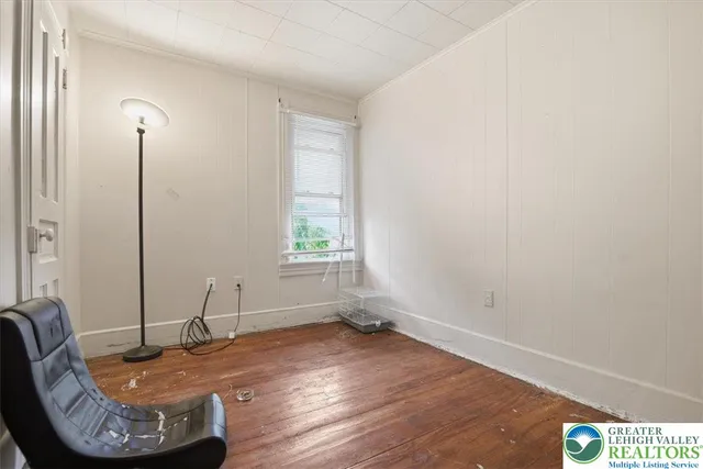 a bedroom with a bed and a desk