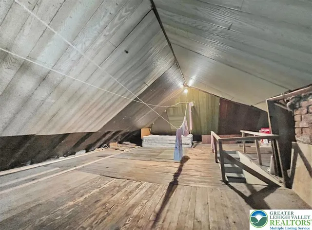 a backyard of a house with plants and large trees