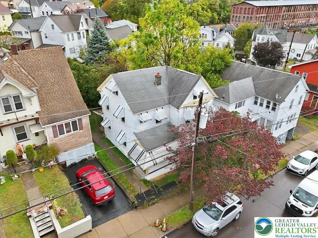 an aerial view of a house with a garden and mountain view