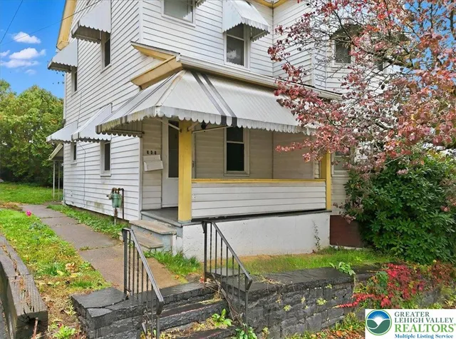 a view of a house with brick walls