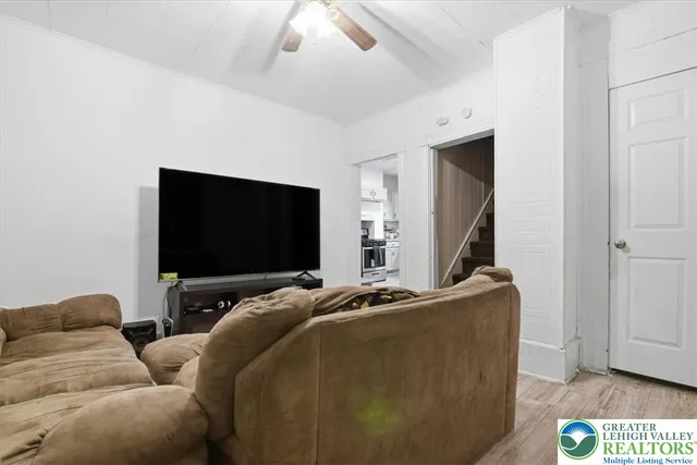a living room with furniture and a flat screen tv