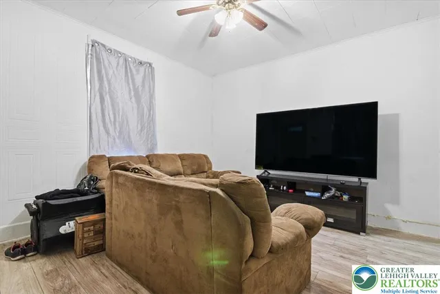 a living room with furniture and a flat screen tv