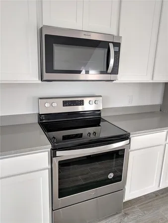 a kitchen with kitchen island a counter space a sink and appliances