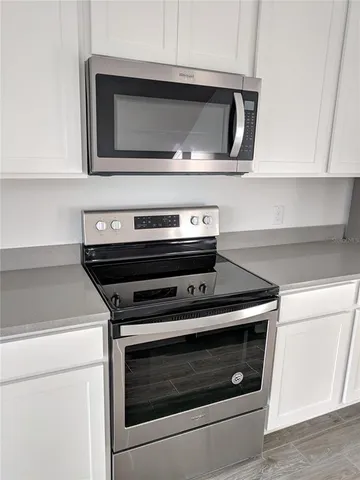 a kitchen with kitchen island a counter space a sink and appliances