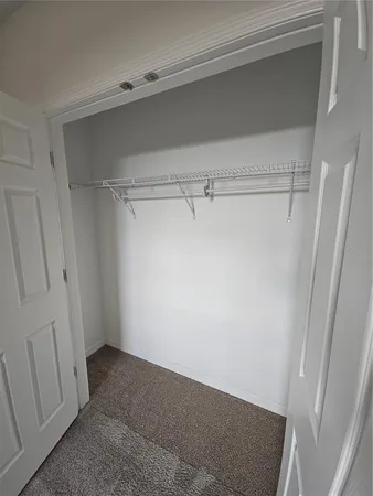 a bathroom with a sink a toilet a mirror and shower