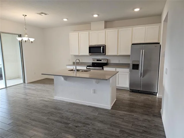 a kitchen with wooden cabinets and stainless steel appliances