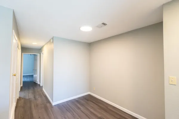 a view of a hallway with wooden floor