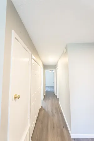 a view of a hallway with wooden floor