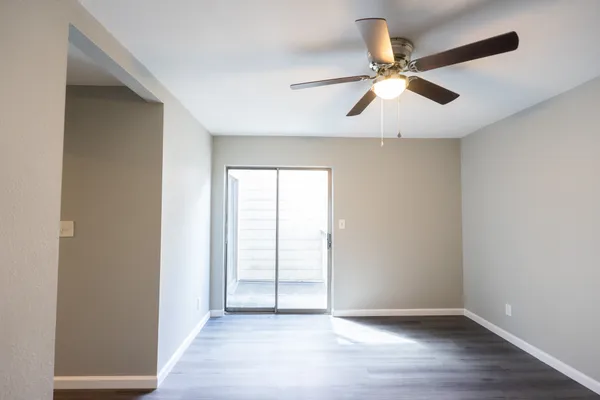 a view of an empty room with wooden floor