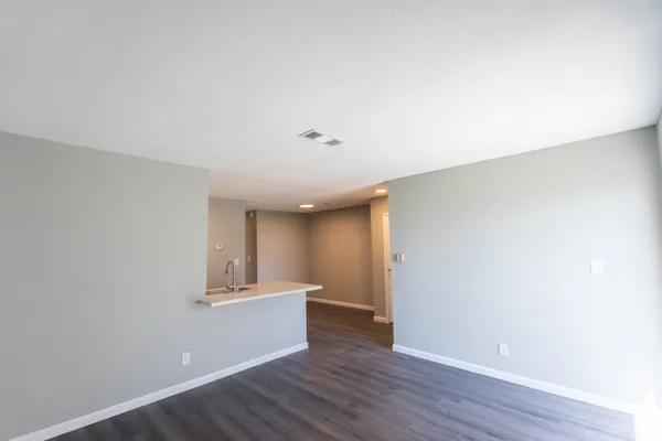 a view of an empty room and wooden floor
