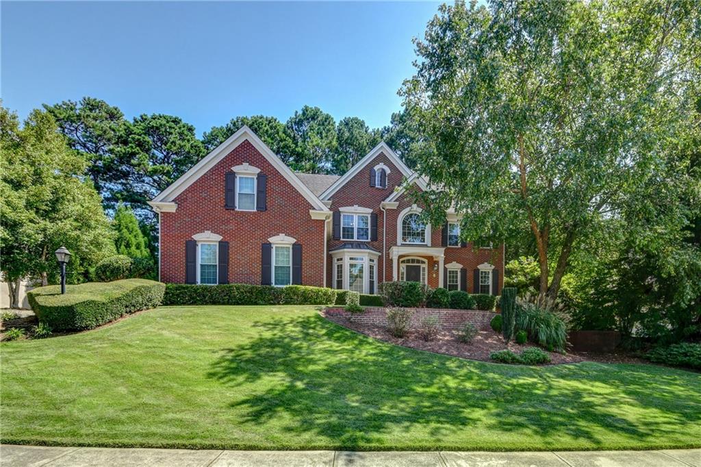 4826 Old Timber Ridge Road Marietta, GA 30068 - Photo 1 of 1 a front view of a house with a yard