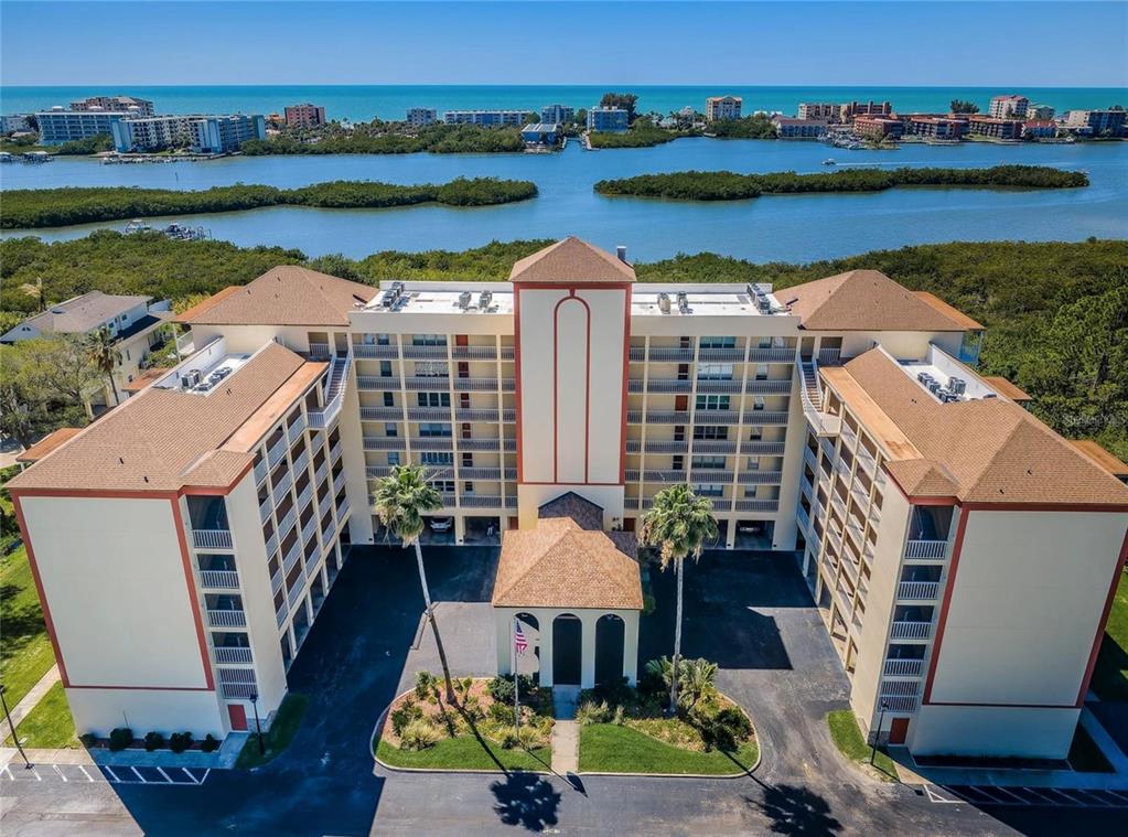 9000 Commodore Drive, Unit 302 Seminole, FL 33776 - Photo 1 of 21 an aerial view of a house with outdoor space lake view and lake view