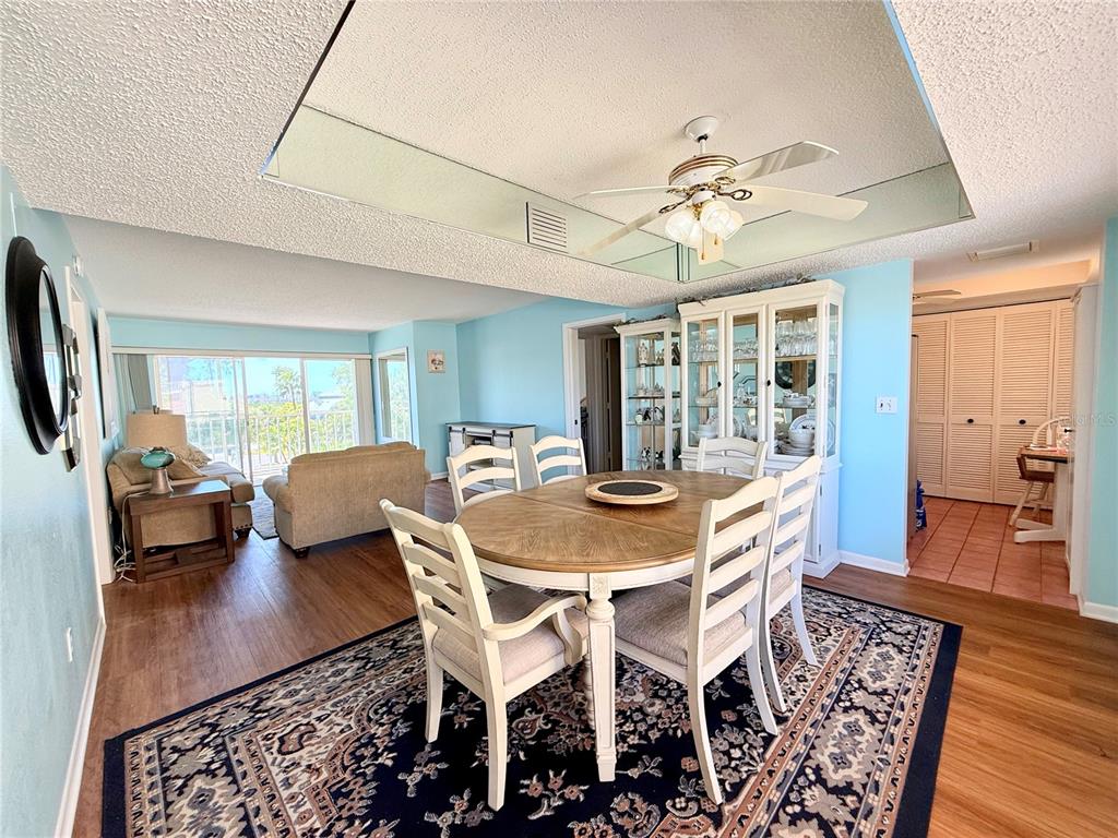 9000 Commodore Drive, Unit 302 Seminole, FL 33776 - Photo 11 of 21 a view of a dining room with furniture and wooden floor