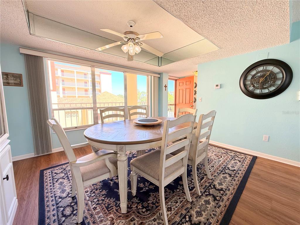 9000 Commodore Drive, Unit 302 Seminole, FL 33776 - Photo 12 of 21 a view of a dining room with furniture window and wooden floor