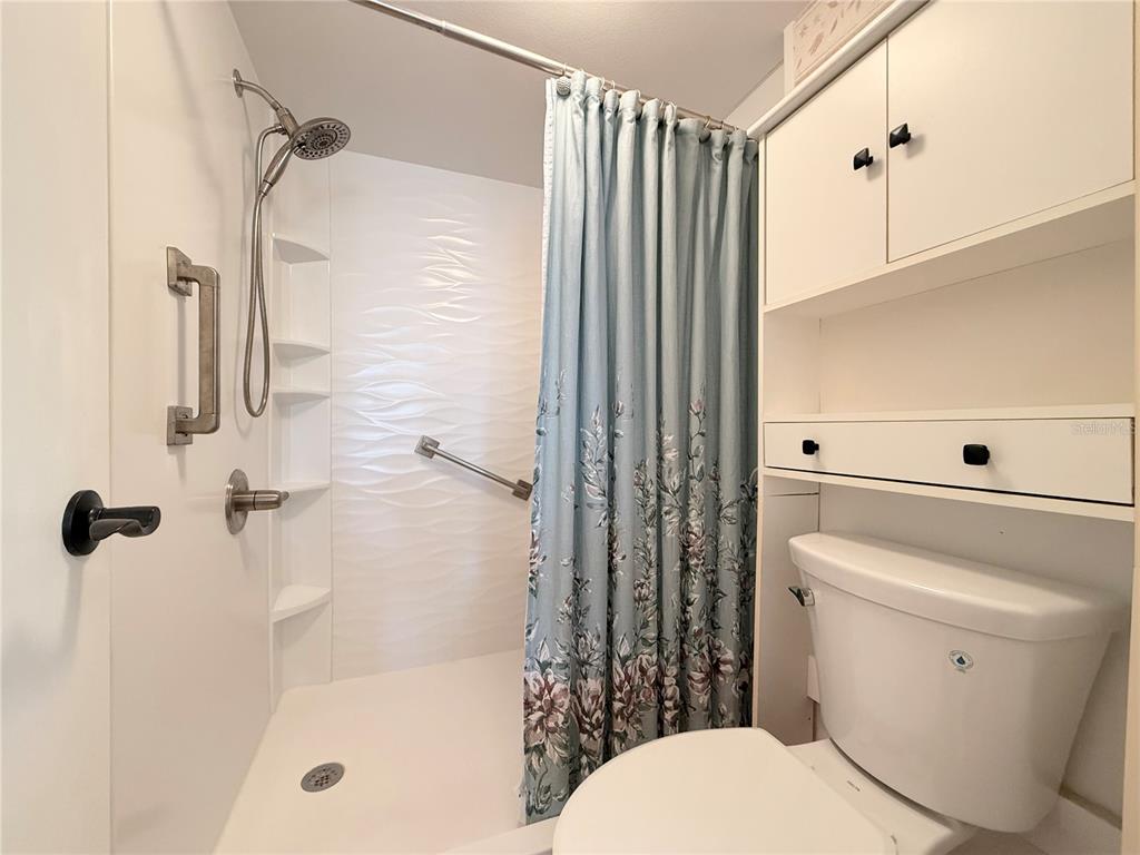 9000 Commodore Drive, Unit 302 Seminole, FL 33776 - Photo 15 of 21 a bathroom with a toilet and a shower