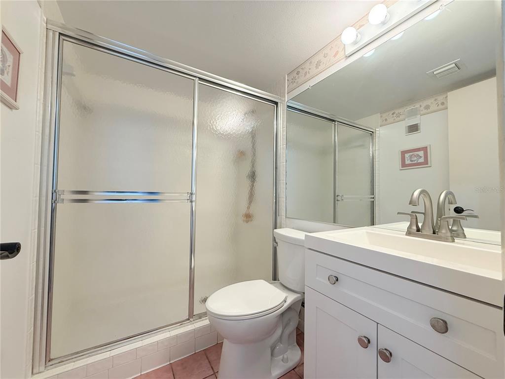 9000 Commodore Drive, Unit 302 Seminole, FL 33776 - Photo 17 of 21 a bathroom with a sink toilet and shower