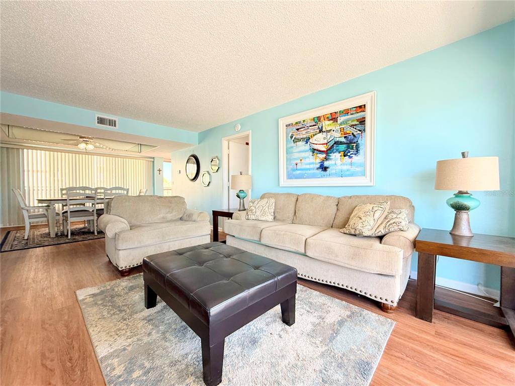 9000 Commodore Drive, Unit 302 Seminole, FL 33776 - Photo 7 of 21 a living room with furniture and wooden floor
