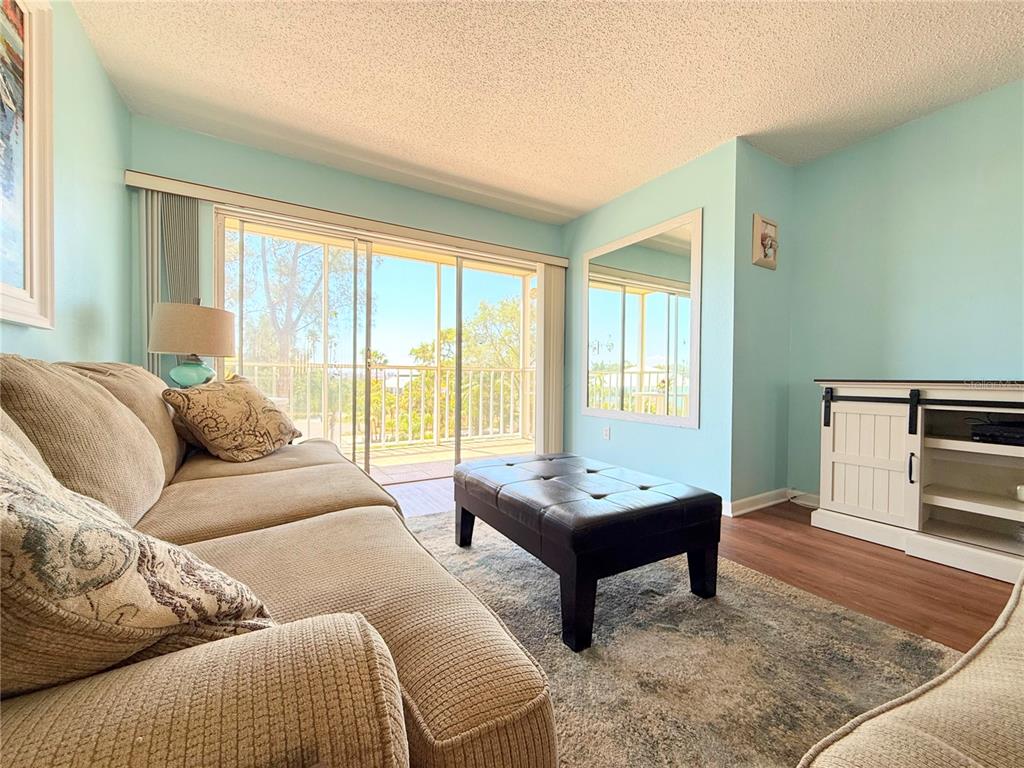 9000 Commodore Drive, Unit 302 Seminole, FL 33776 - Photo 8 of 21 a living room with furniture and a window