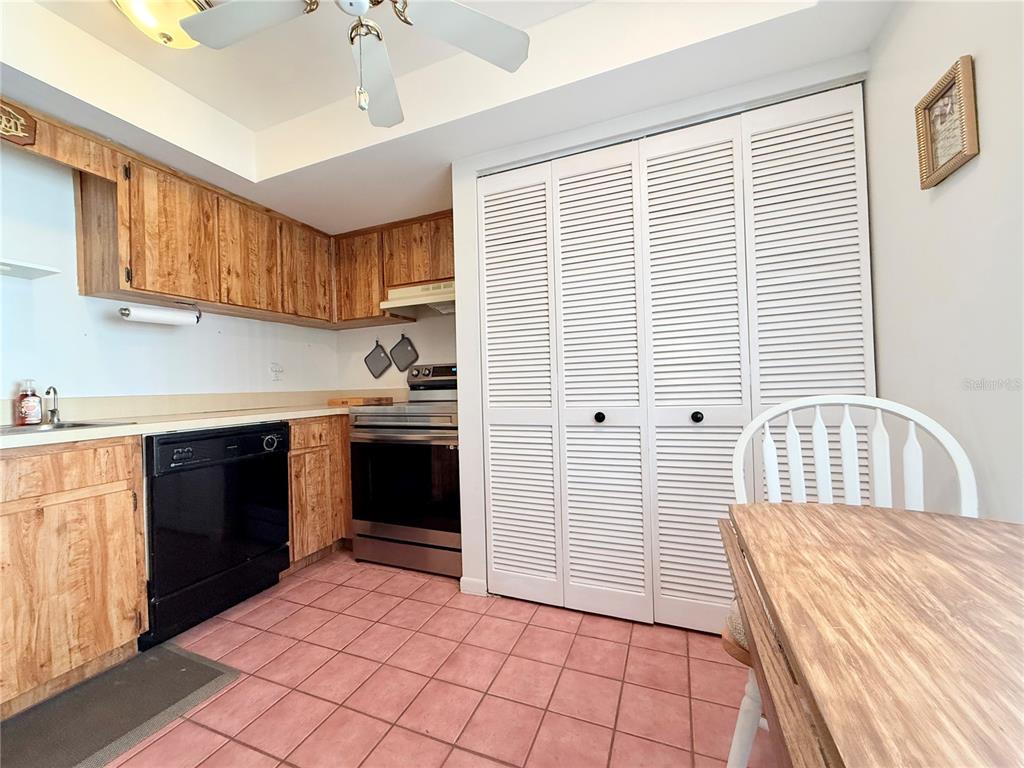 9000 Commodore Drive, Unit 302 Seminole, FL 33776 - Photo 10 of 21 a kitchen with a sink a stove and cabinets