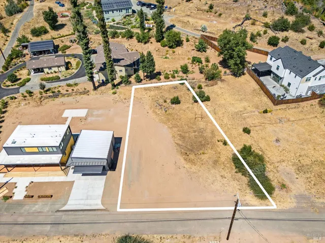 an aerial view of residential houses with outdoor space
