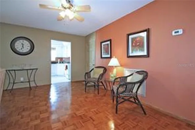 a dining room with furniture and a large window