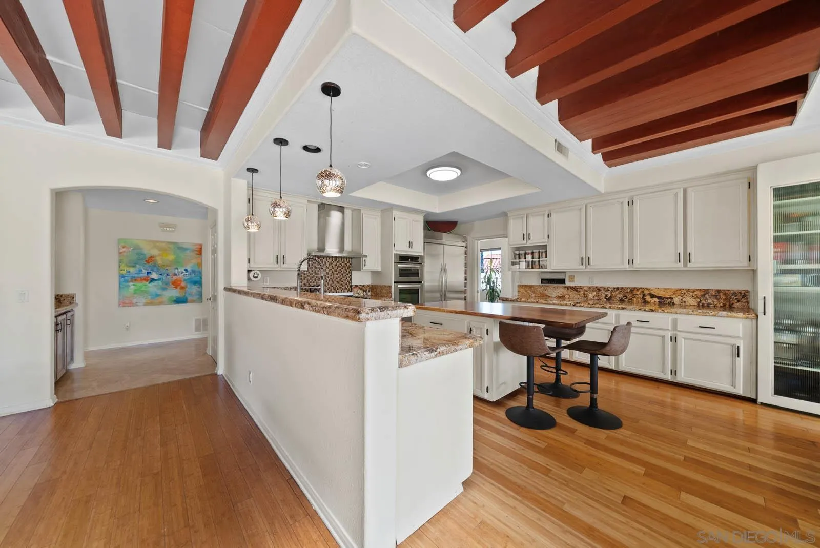 308 Crestview Drive Bonita, CA 91902 - Photo 17 of 37 a kitchen with cabinets and wooden floor