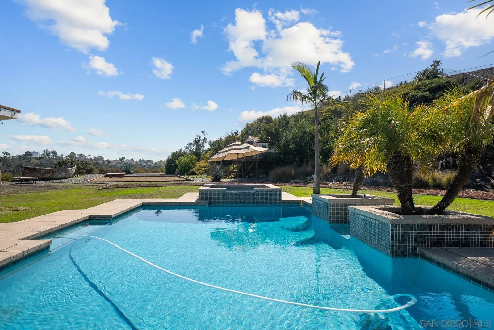 308 Crestview Drive Bonita, CA 91902 - Photo 28 of 37 a view of a swimming pool with a table and chairs