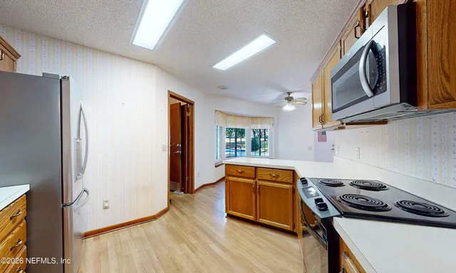 a kitchen with stainless steel appliances granite countertop a stove a washer and dryer