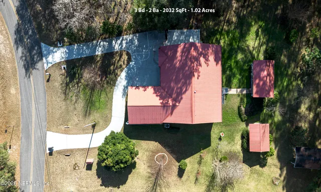 an aerial view of a houses with yard