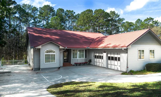 a front view of a house with a garden and yard