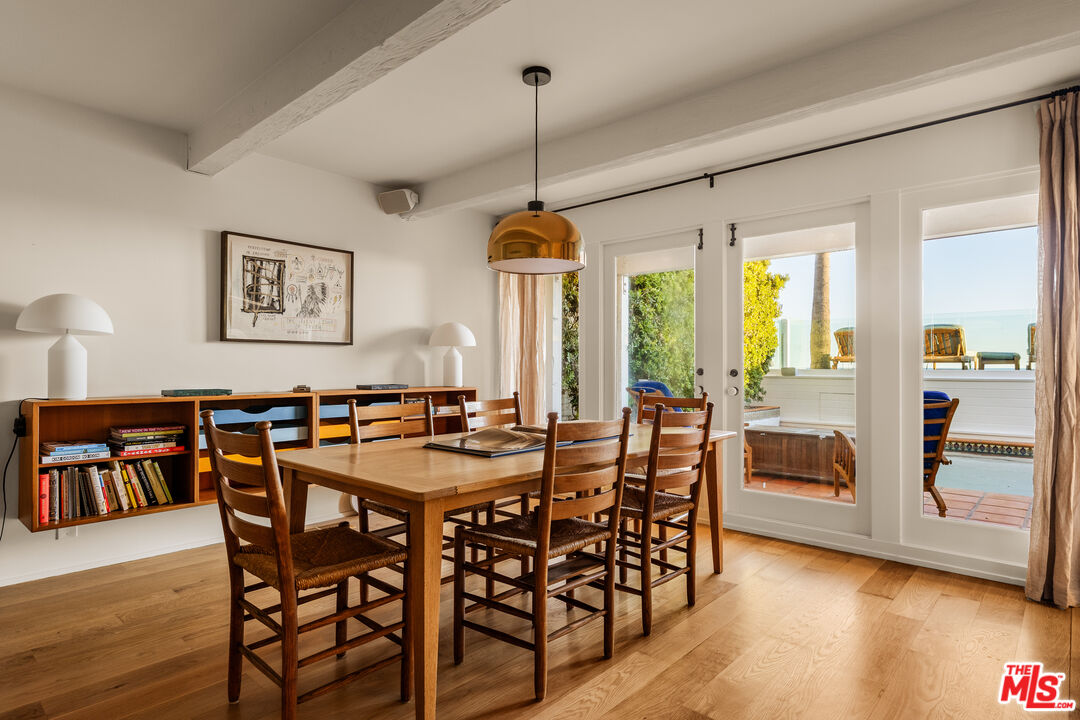 23422 Malibu Colony Road, Unit 98 Malibu, CA 90265 - Photo 17 of 42 a view of a dining room with furniture window and wooden floor