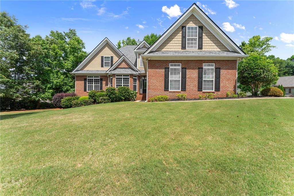 6643 Windvane Point Clermont, GA 30527 - Photo 87 of 88 a front view of a house with a yard and trees
